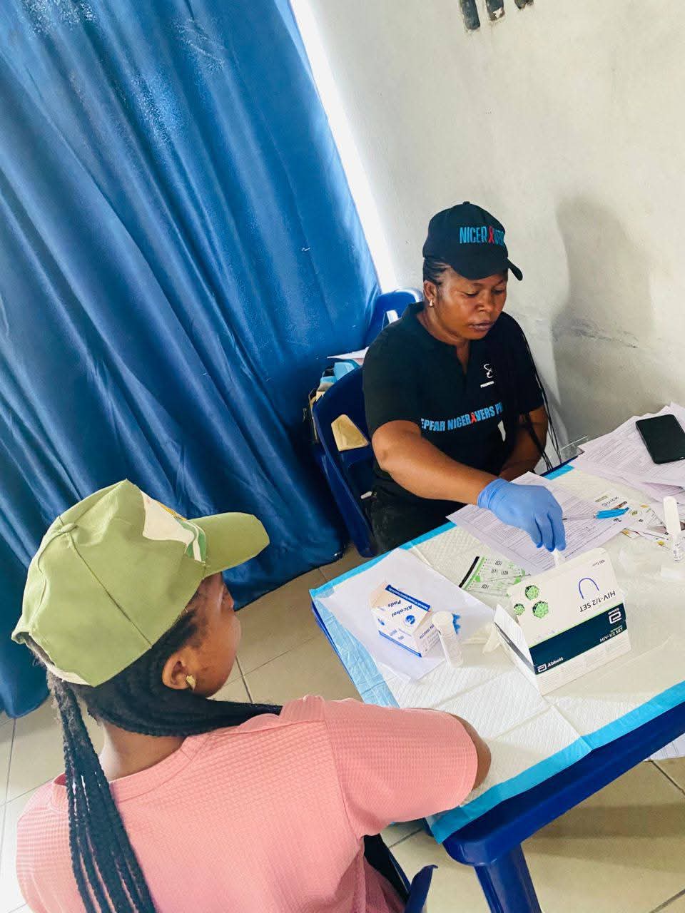 A health worker conducting HIV testing services with a young client in Rivers State